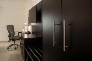 a black cabinet with a desk and a chair in a room at Holiday Inn Express Tapachula, an IHG Hotel in Tapachula