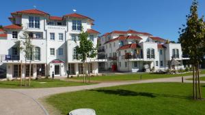 a group of large white buildings in a park at Zum Inselparadies, Haus Meeresblick in Baabe