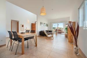 a living room with a table and chairs at Villa Marisa I in Alcudia