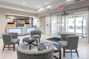 a waiting room with chairs and a table at Holiday Inn Express Hotel & Suites Lagrange I-85, an IHG Hotel in La Grange