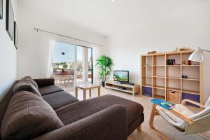 a living room with a couch and a television at Villa Marisa I in Alcudia