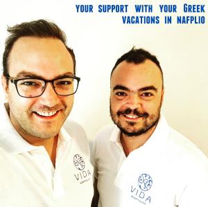 two men in white shirts posing for a picture at Vida Residential Apartments in Nafplio