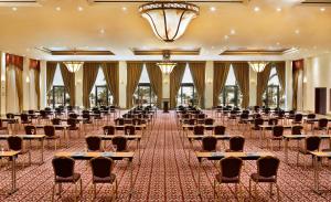 a banquet hall with chairs and tables and a chandelier at InterContinental Aqaba by IHG in Aqaba