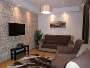 a living room with a couch and a flat screen tv at Retiro da Estrela in Seia