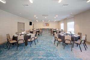 a conference room with tables and chairs and a podium at Holiday Inn Los Angeles - LAX Airport by IHG in Los Angeles +33 photos