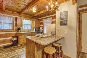 a kitchen with a center island in a log cabin at Puppy Love #1619 in Gatlinburg