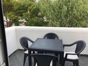 einen schwarzen Tisch und Stühle auf einer Terrasse in der Unterkunft Apartamento en La Almadraba in Chiclana de la Frontera