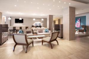 a living room with furniture and a dining room at Holiday Inn Los Angeles - LAX Airport, an IHG Hotel in Los Angeles