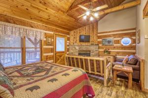a log cabin bedroom with a bed and a fireplace at Puppy Love #1619 in Gatlinburg