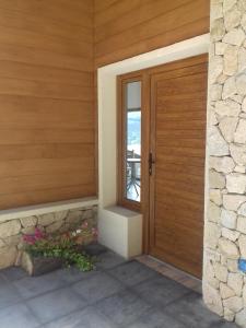 a wooden door to a house with a patio at Altos de Esquel in Esquel