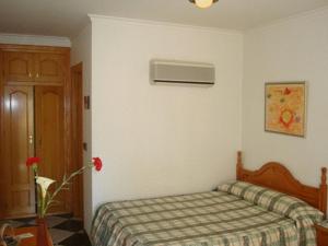 Postel nebo postele na pokoji v ubytování Hotel Guillermo II