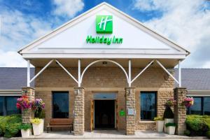 a building with the entrance to a holiday inn at Holiday Inn Leeds Brighouse by IHG in Brighouse