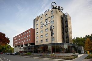 a hotel building with a sign on top of it at Bastion Hotel Den Haag Rijswijk in Rijswijk