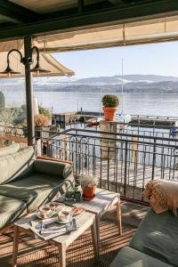 a balcony with couches and a view of the water at Hotel Hirschen am See in Meilen