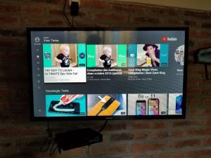a flat screen tv hanging on a brick wall at Hospedaje lo de la Ñata in Trinidad