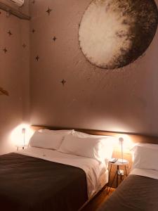 a bedroom with a moon mural on the wall at Franca City Hostel in Buenos Aires