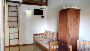 a room with a bed and a ladder and a tv at Complejo Refugios Marinos in Valeria del Mar +28 photos