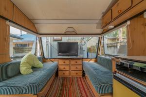 a living room with a tv and a couch and a tv at Rose's Beach Pad - Matarangi Holiday Home in Matarangi