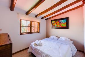 a bedroom with a bed and a tv on the wall at Hostal Doña Eliza in Bogotá