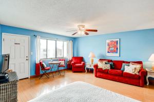 a living room with a red couch and red chairs at Hidden Beach Villas 215 in Santa Rosa Beach