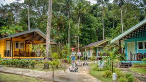 a group of people standing in front of a house at Nirwana Beach Club in Lagoi