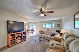 a living room with a couch and a flat screen tv at Cozy Cedar House - Family-Friendly Home with Yard! in Cortez