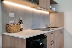 a kitchen with a refrigerator and a sink at Parklands Resort & Conference Centre in Mudgee