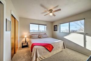 a bedroom with a bed and a ceiling fan at Family-Friendly Cortez Cedar House with Yard! in Cortez