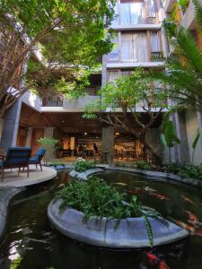 a koi pond in the courtyard of a building at Minh Boutique in Danang