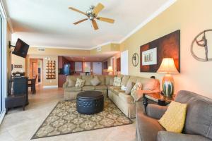 a living room with a couch and a ceiling fan at Palazzo II in Panama City Beach