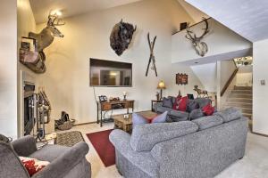 a living room with couches and antlers on the wall at Eclectic Eagle-Vail Condo 2 Miles to Beaver Creek in Beaver Creek