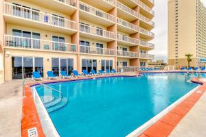 a swimming pool in front of a hotel at Sunrise Beach Resort V in Panama City Beach