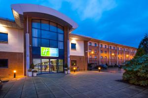 a building with a sign on the front of it at Holiday Inn Express Newport, an IHG Hotel in Newport