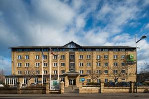 a large brick building with a sign in front of it at Holiday Inn Express Edinburgh - Leith Waterfront by IHG in Edinburgh +21 photos