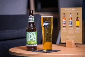 a bottle of beer on a table with a glass at Holiday Inn Express Edinburgh - Leith Waterfront by IHG in Edinburgh