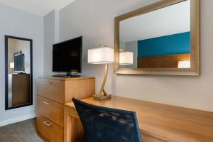 a living room with a chair and a lamp at Staybridge Suites - Orlando Royale Parc Suites, an IHG Hotel in Orlando