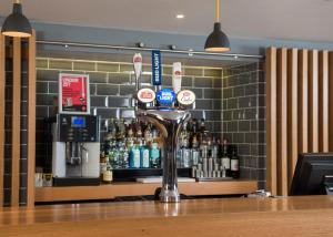 a bar with bottles of alcohol on a counter at Holiday Inn Express Edinburgh - Leith Waterfront by IHG in Edinburgh