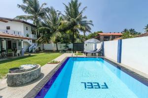 a swimming pool in the backyard of a house at FEEL Villa in Kalutara