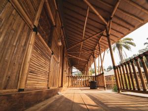 a large wooden building with a wooden roof at Tadom Hill Resorts in Kampong Labohan Dagang