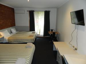 Postel nebo postele na pokoji v ubytování Werribee Motel and Apartments