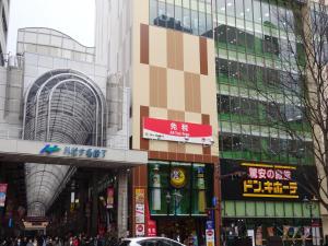 a busy street in a city with tall buildings at Hotel Green Pacific in Sendai