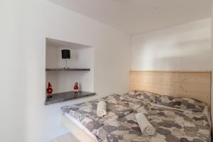 a bedroom with a bed in a white room at Old Mill House in Bohinj