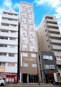 two tall buildings next to each other on a street at Hotel Trend Tobu Asakusa-Eki Kita in Tokyo