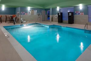 a large swimming pool with blue water at Holiday Inn Express & Suites - Wilmington West - Medical Park, an IHG Hotel in Wilmington