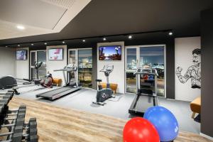 a gym with treadmills and exercise equipment and balloons at Holiday Inn - Hamburg - HafenCity, an IHG Hotel in Hamburg