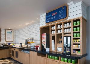 a counter in a restaurant with a coffee shop at Holiday Inn Express Edinburgh - Leith Waterfront by IHG in Edinburgh