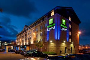 a building with blue and green lights on it at Holiday Inn Express Edinburgh - Leith Waterfront by IHG in Edinburgh