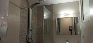 a bathroom with a shower and a mirror at Apartamento Mar deluxe Suances in Suances