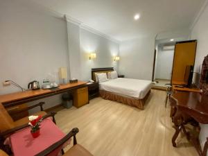 Postel nebo postele na pokoji v ubytování Mariani International Hotel