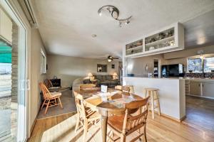 a dining room and kitchen with a table and chairs at Family-Friendly Cortez Cedar House with Yard! in Cortez